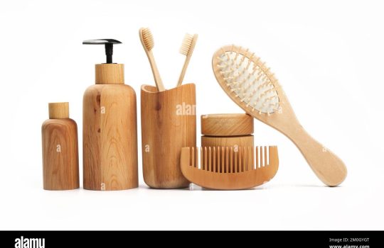 close-up-beauty-care-and-personal-hygiene-products-in-wooden-containers-toothbrushes-and-comb-isolated-on-white-background-low-angle-side-view-cl-2M0GYGT